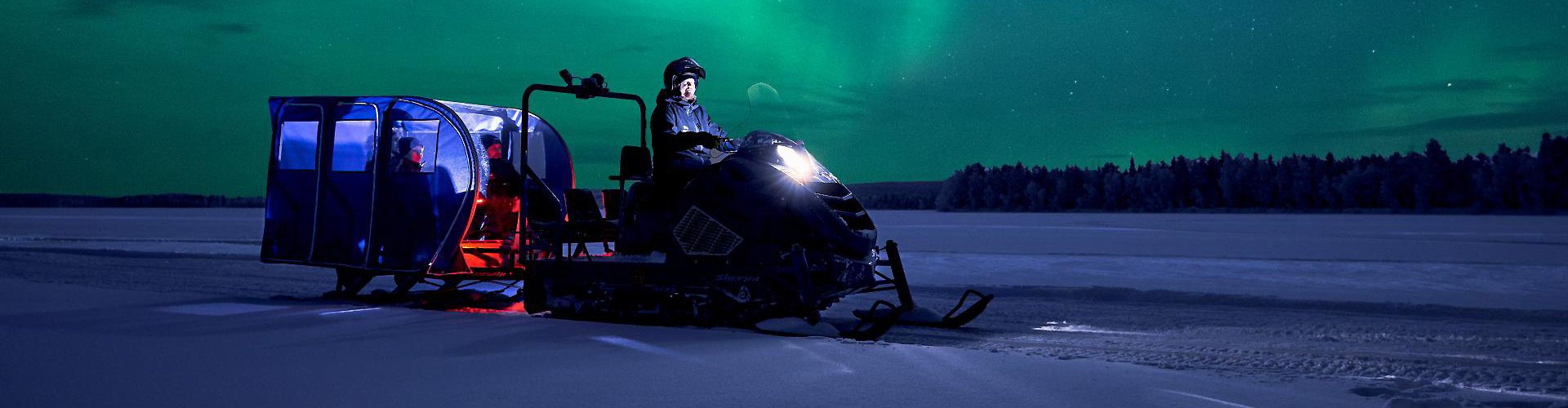 Alpina Sherpa with Transalp Bus: professional passenger transport snowmobiles for Northern Lights tours and Arctic tourism.