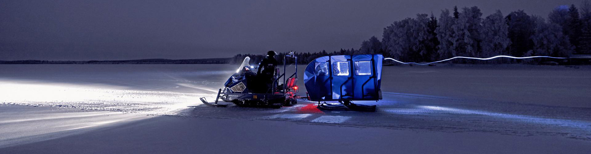 Alpina Snow-bus: professional dual-track passenger snowmobiles for northern lights tours and Arctic lake crossings.