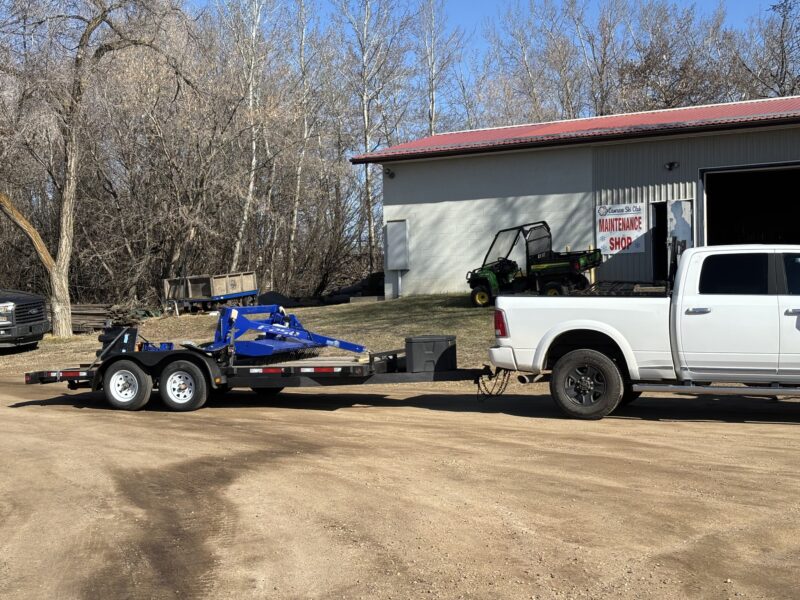 Alpina F-250 cross-country ski groomer on a trailer, delivered to Camrose Ski Club in Canada, ready for trail grooming.